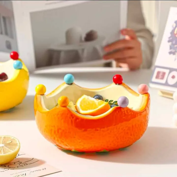 Orange fruits bowl with fork